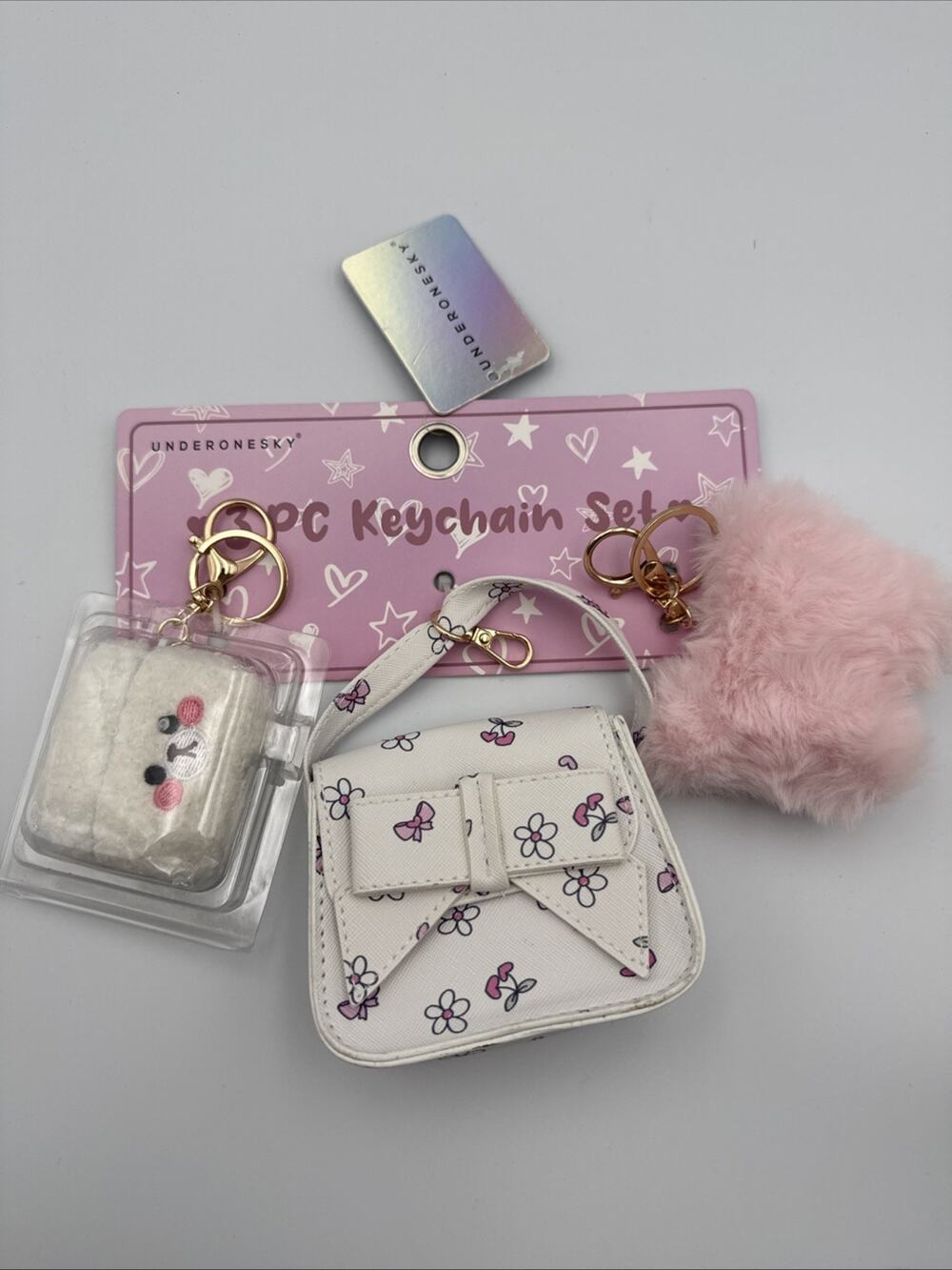 Under One Sky 3 PC Key Chain Set - 1 Airpod Case, 1 Mini Bag, 1 Pom Pom - New